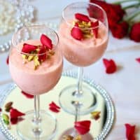 Firni in stem glasses decorated with rose petals and crushed pistachio