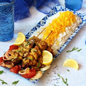 Persian joojeh kabob on a bed of saffron rice.