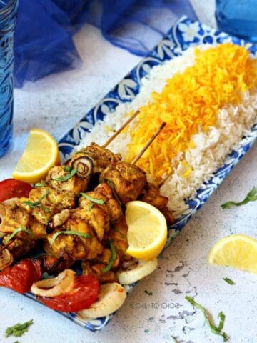 Persian joojeh kabob on a bed of saffron rice.