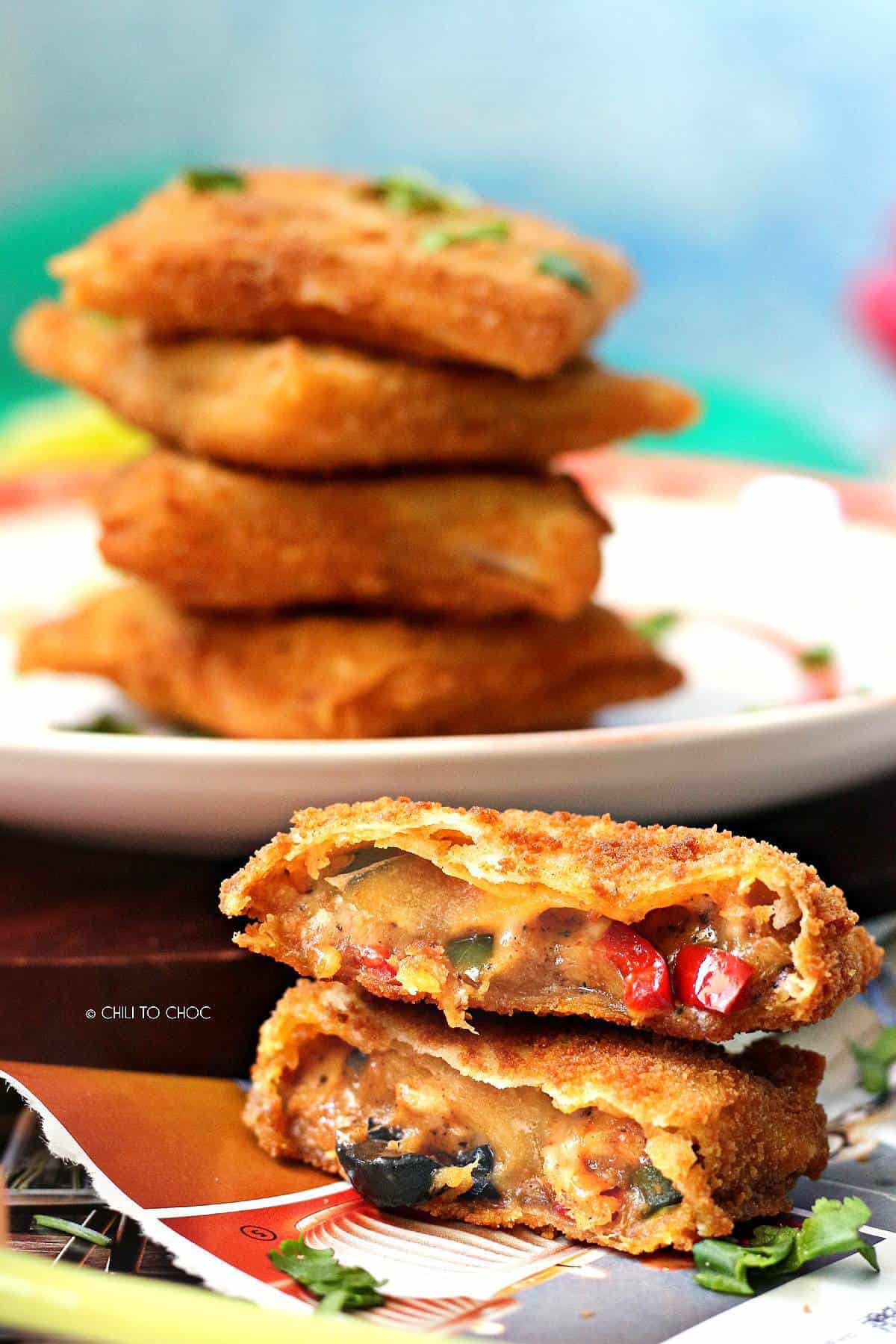 Half cut box samosa with inside filling shown.