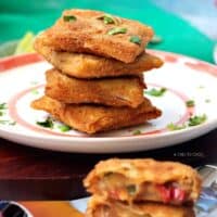 Chicken and cheese box patties stacked on a plate