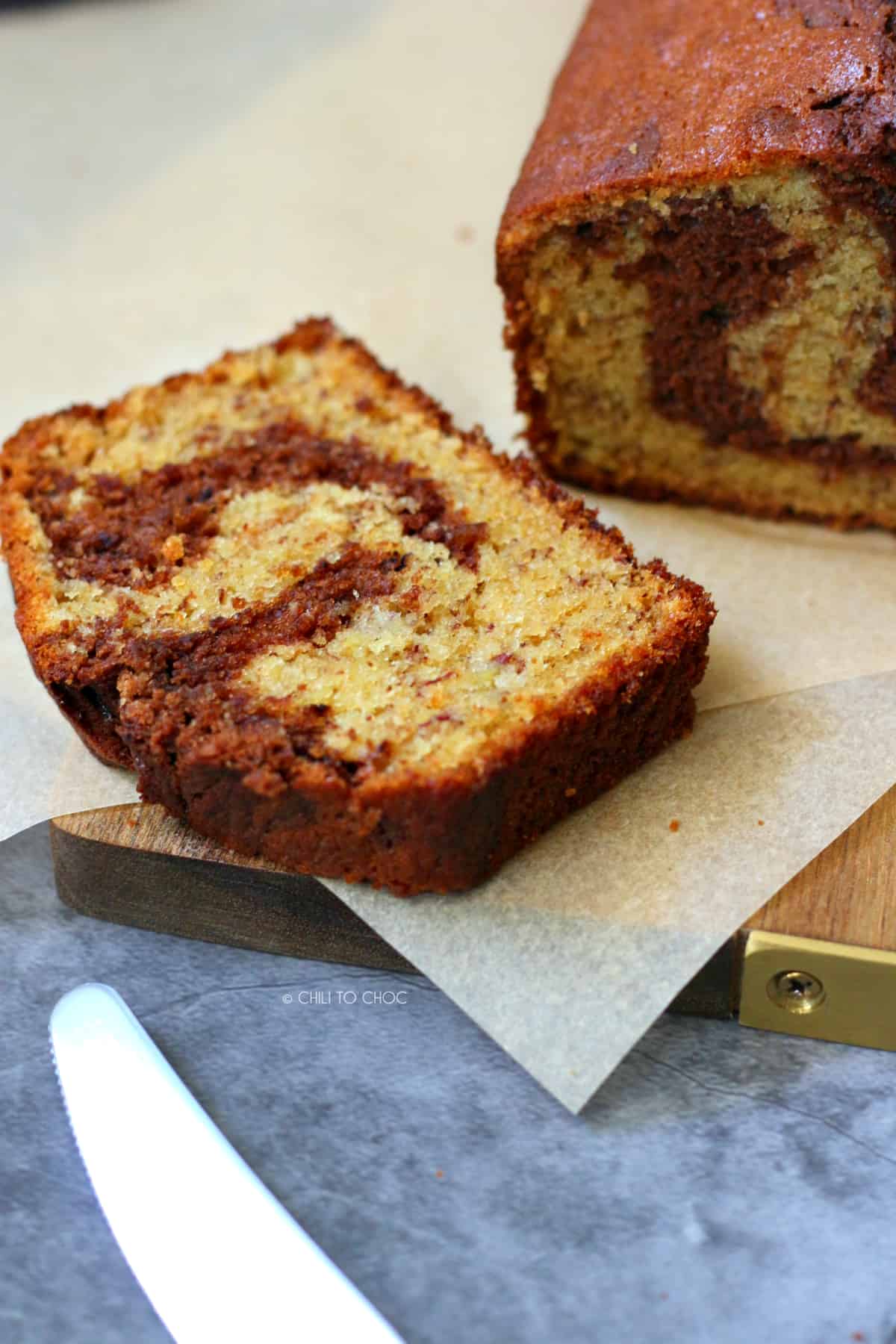 Sliced Chocolate Marbled Banana Bread on a wooden board