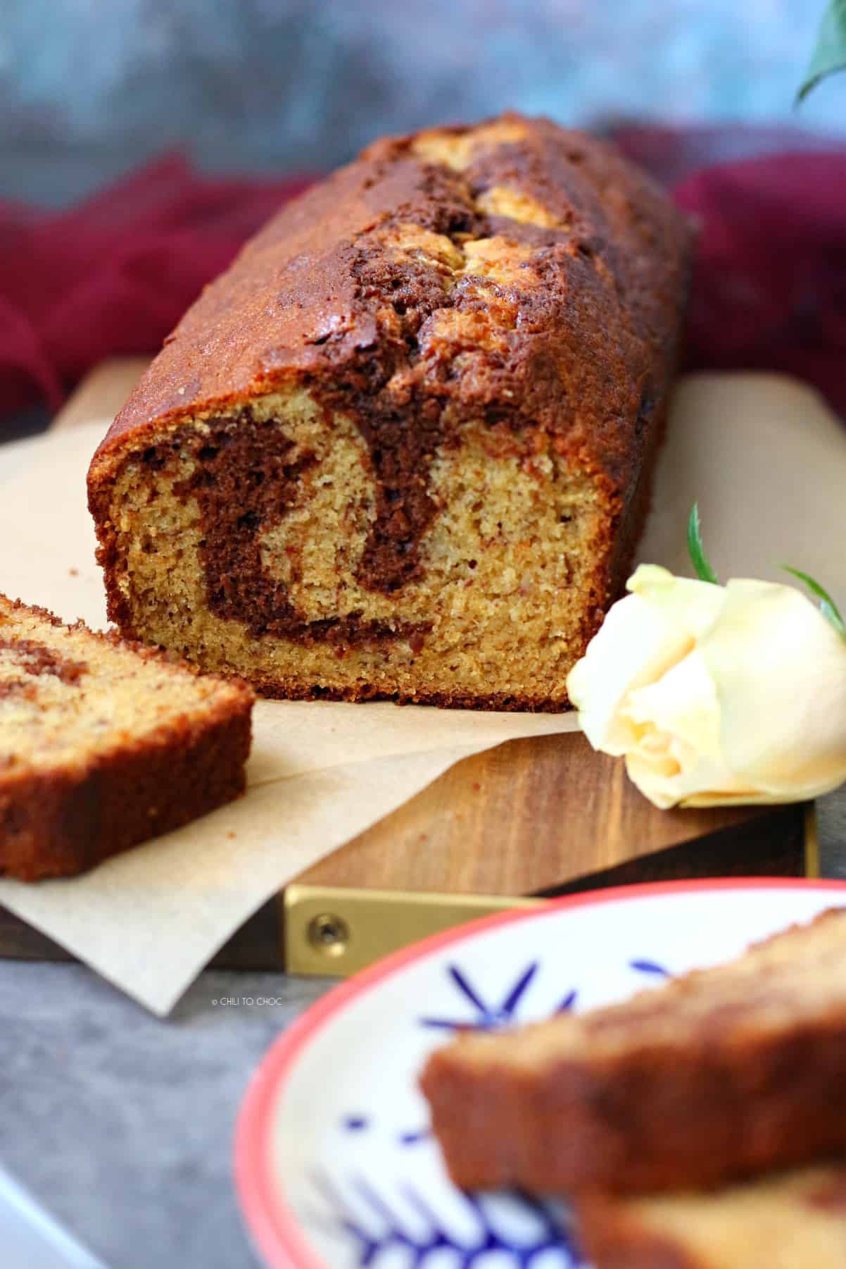 Sliced Chocolate Marbled Banana Bread on a wooden board