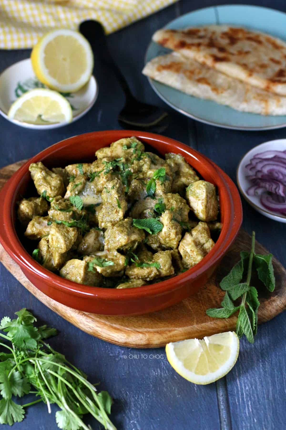 Chicken Hara Masala in a clay bowl garnished with coriander.