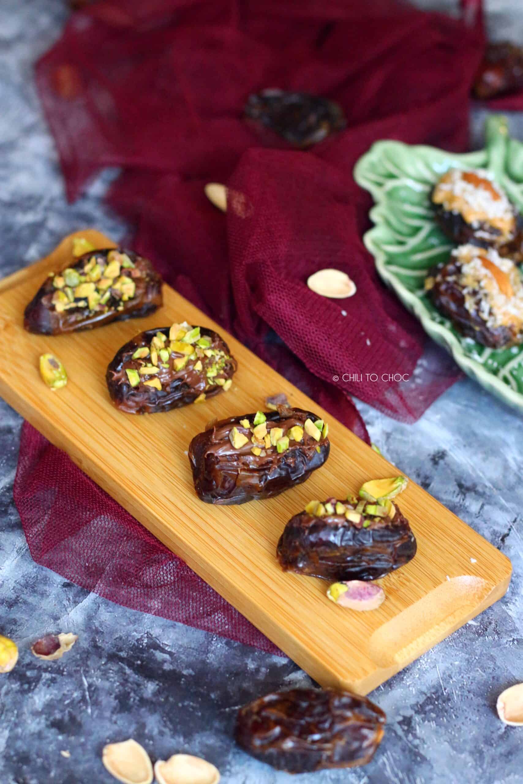 nutella and pistachio dates on a small brown tray