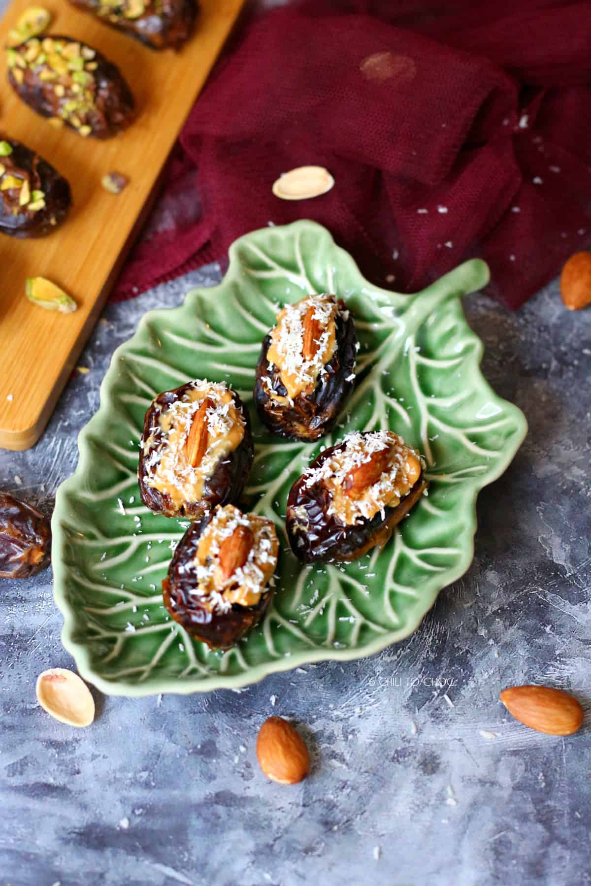 peanut butter and almond dates on a green plate