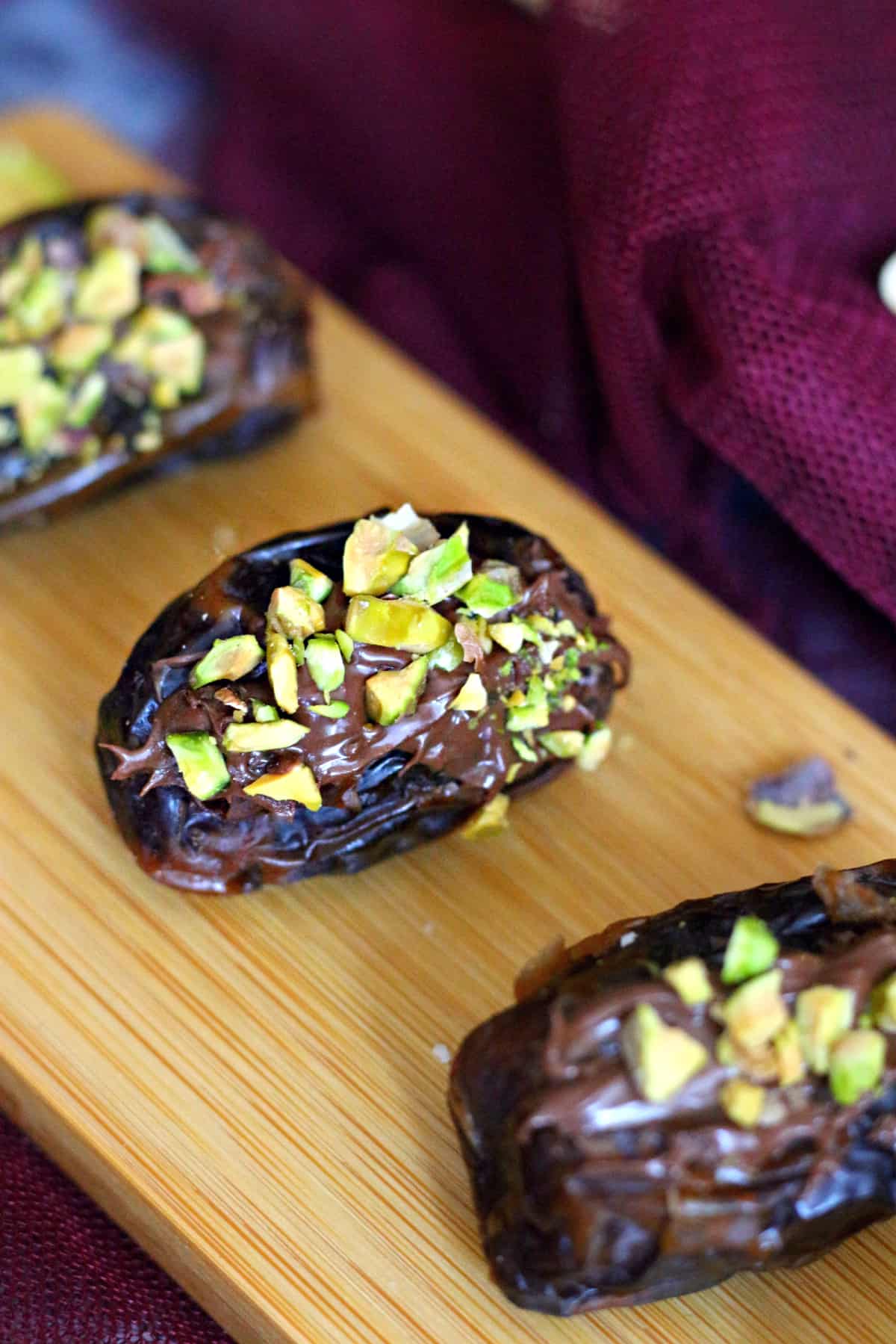 closeup of stuffed date with nutella and chopped pistachios 