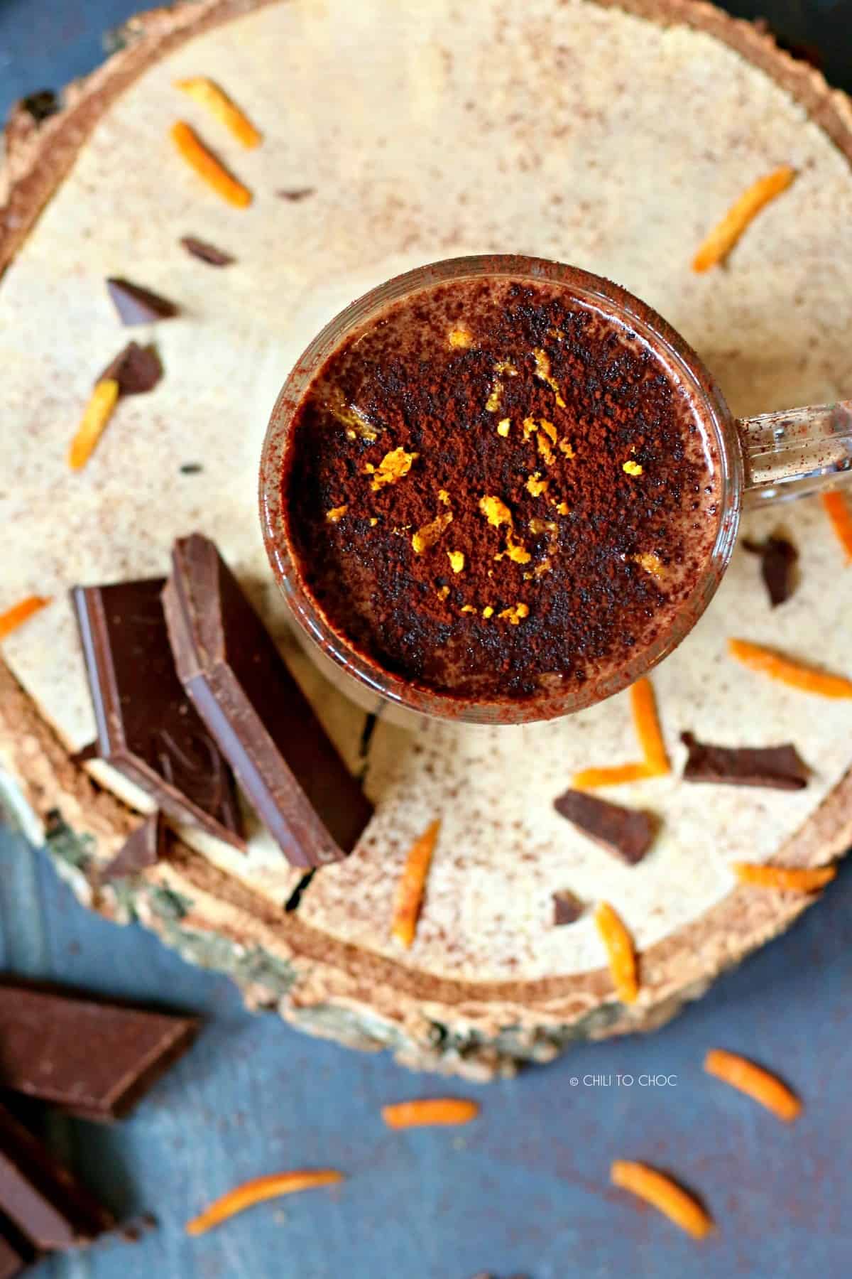 Top shot of hot chocolate with cocoa powder dusting and orange zest.