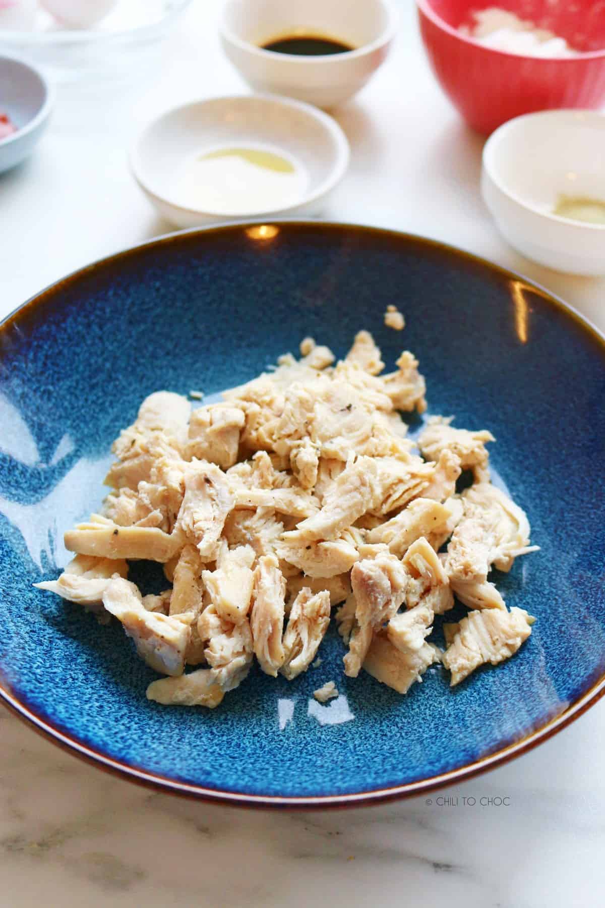 Shredded chicken in a blue plate.