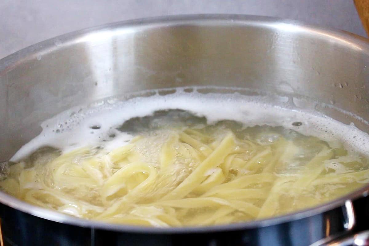 Boiling tagliatelle pasta in a pot.