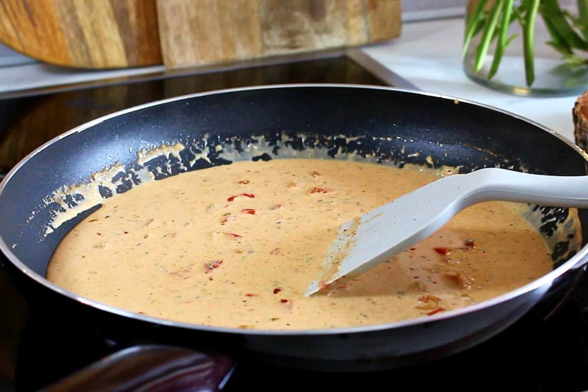 Making the creamy Cajun sauce.