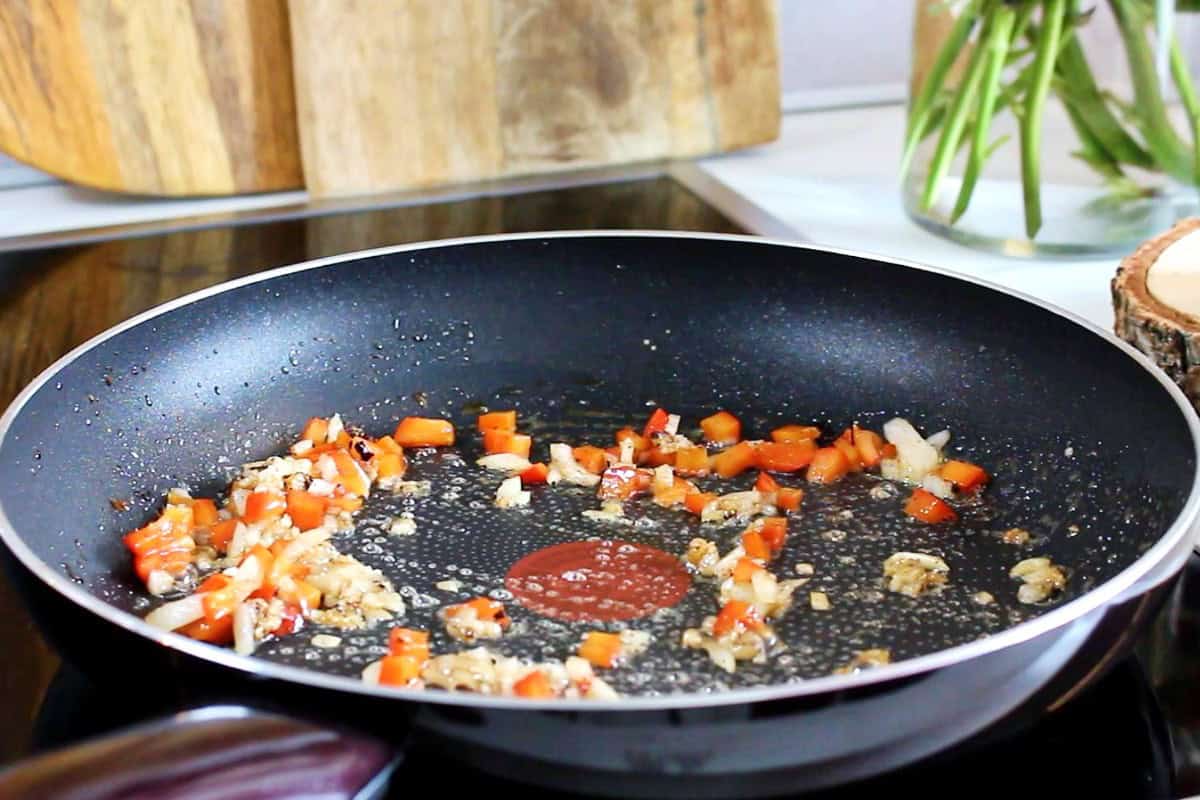 Sauteing veggies with butter in a pan.