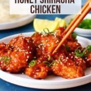 Picking honey sriracha chicken with a chopstick.