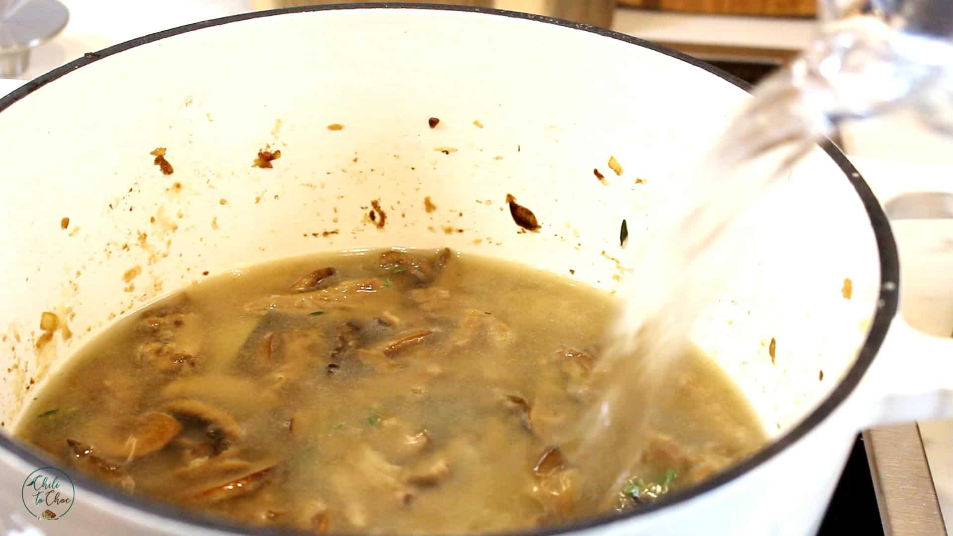 Add water to mushrooms in a white pot.