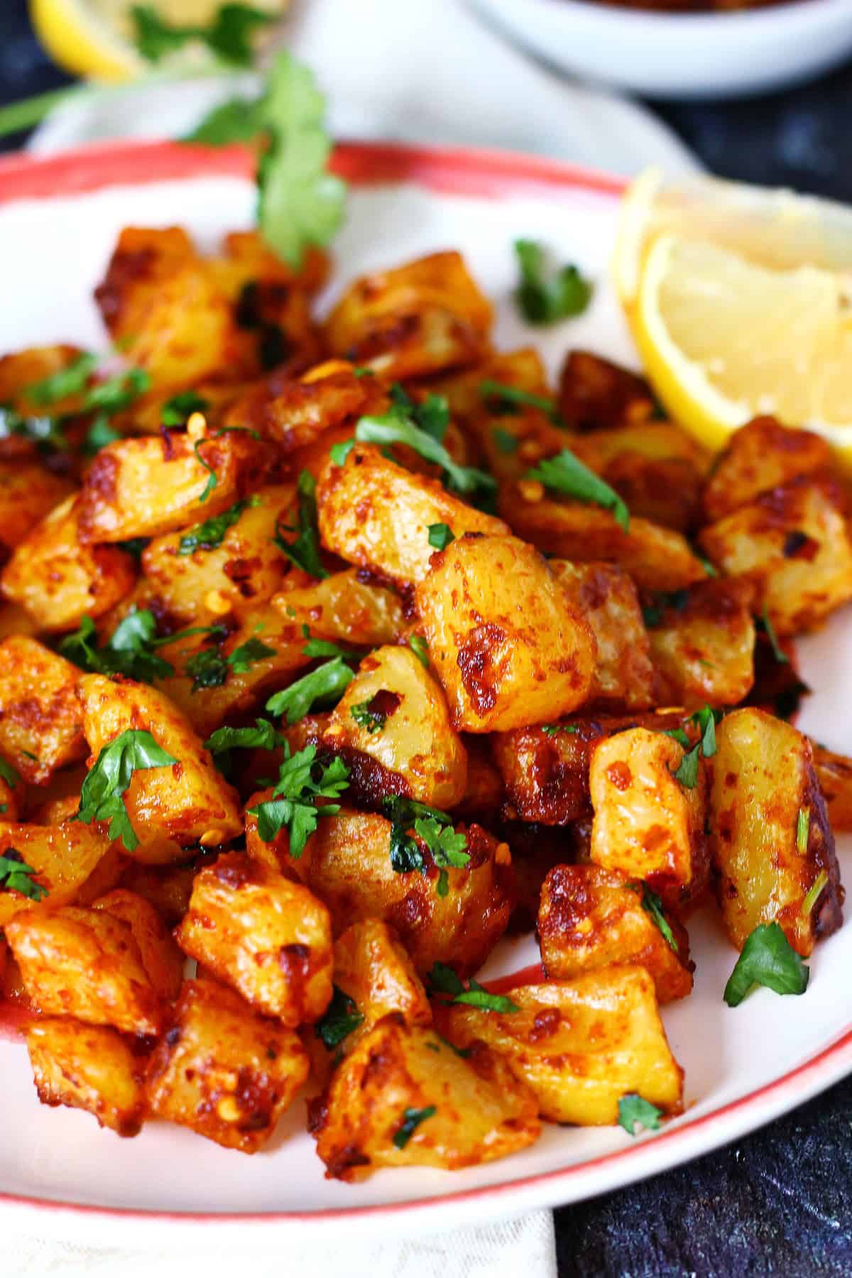 Spicy Lebanese potatoes in a plate garnished with cilantro.