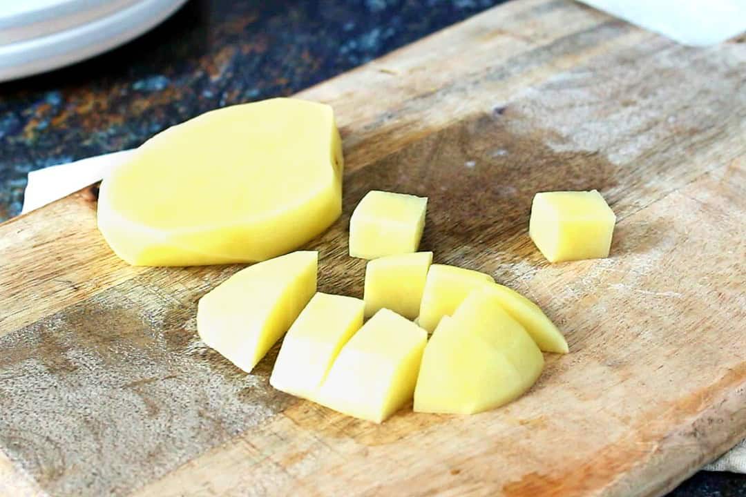 Cubed potatoes on a chopping board.