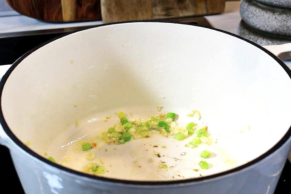 Ginger, garlic and green onion sautéing in a Dutch pot.