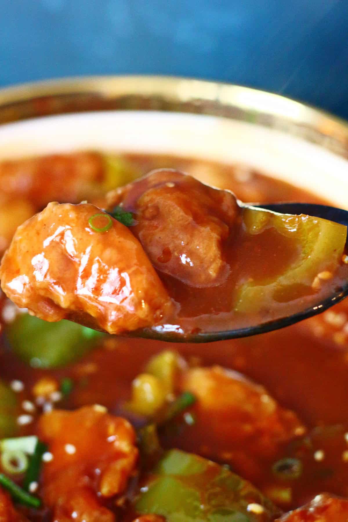 Close up of chicken Manchurian in a serving spoon.