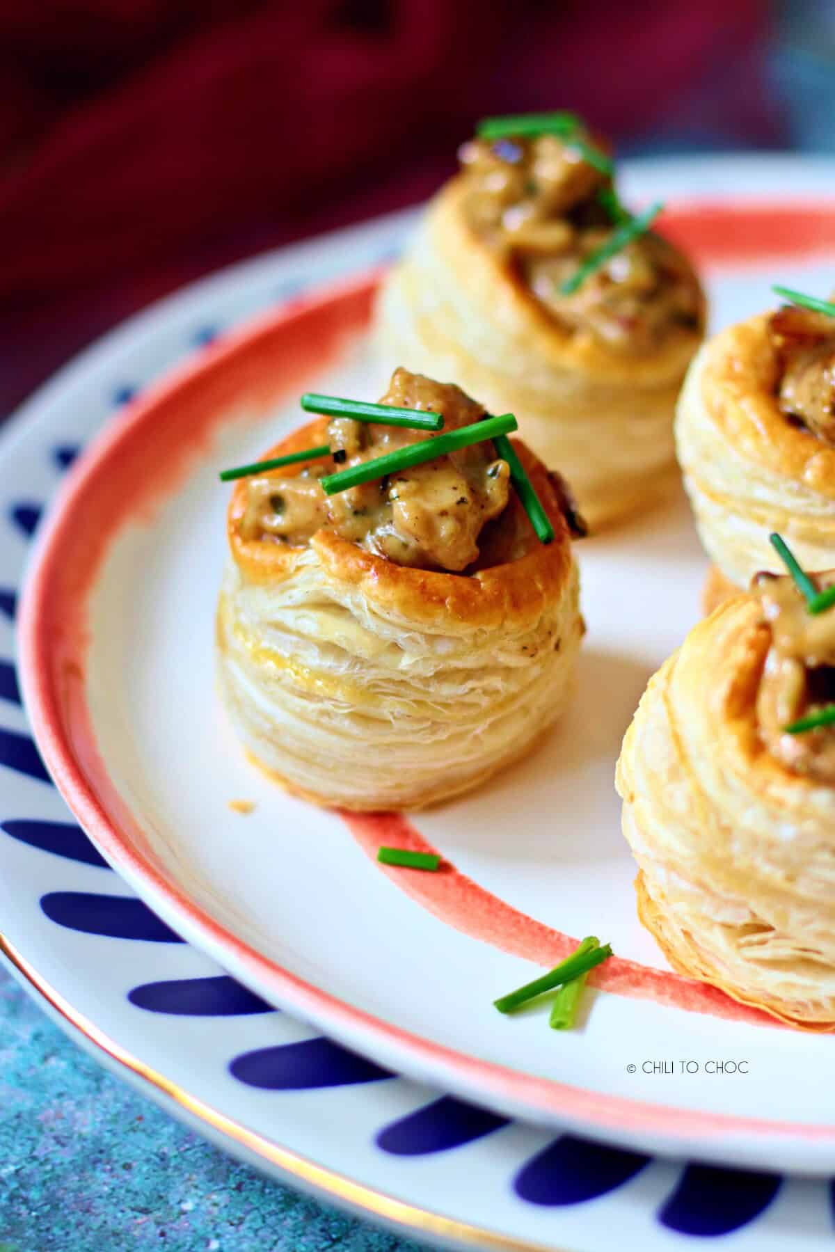 Vol au vents on a plate garnished with chives.