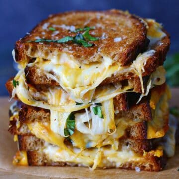 Stacked slices of sourdough grilled cheese.