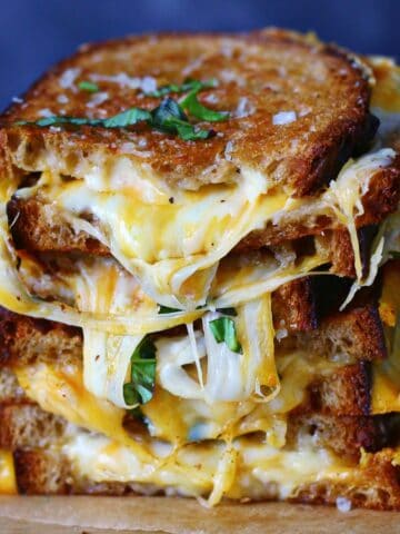 Stacked slices of sourdough grilled cheese.