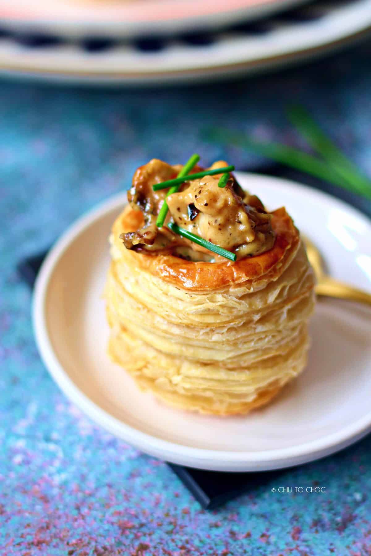 A chicken and mushroom vol au vent garnished with chives.