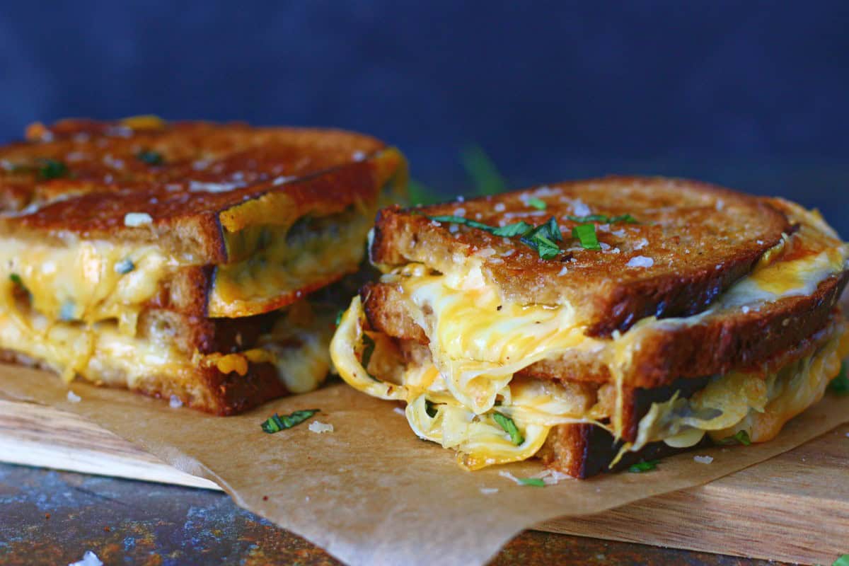 Two stacks of grilled cheese sandwich side by side.