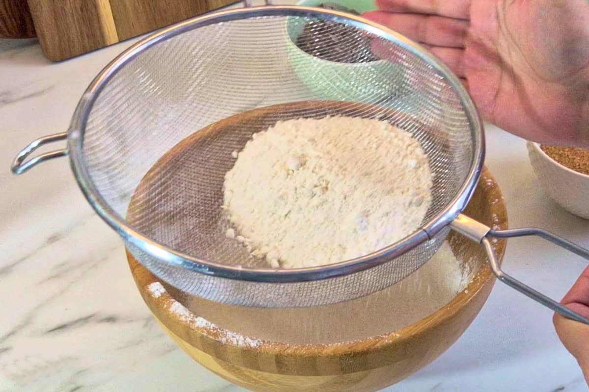 Sifting fry ingredients in a sieve.