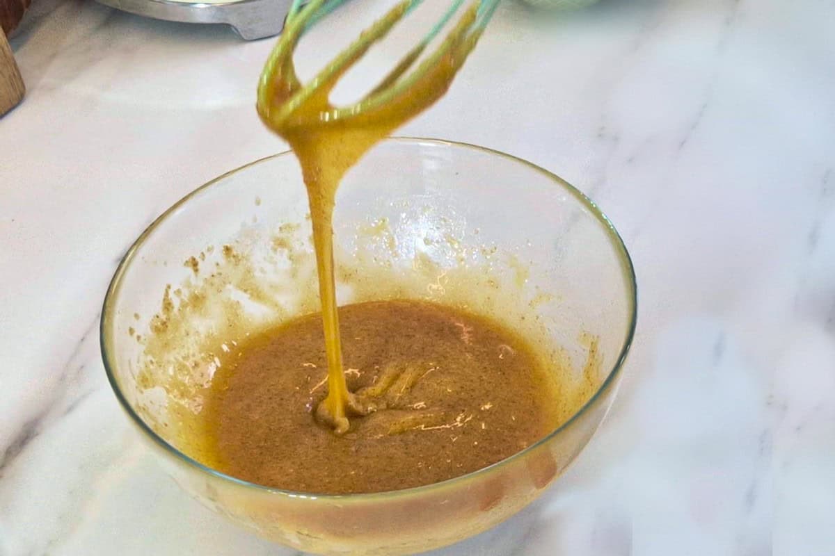 Mixing wet batter with a whisk.