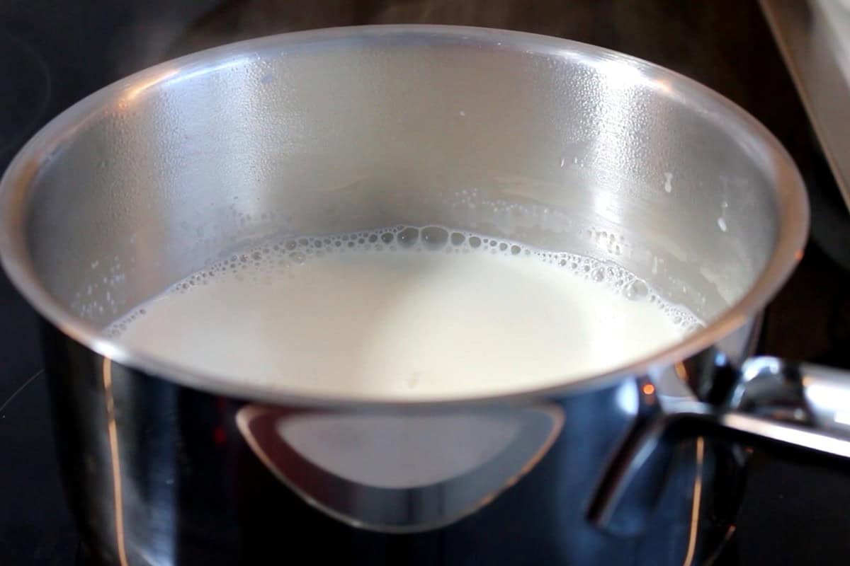 Simmering milk in a steel pot.