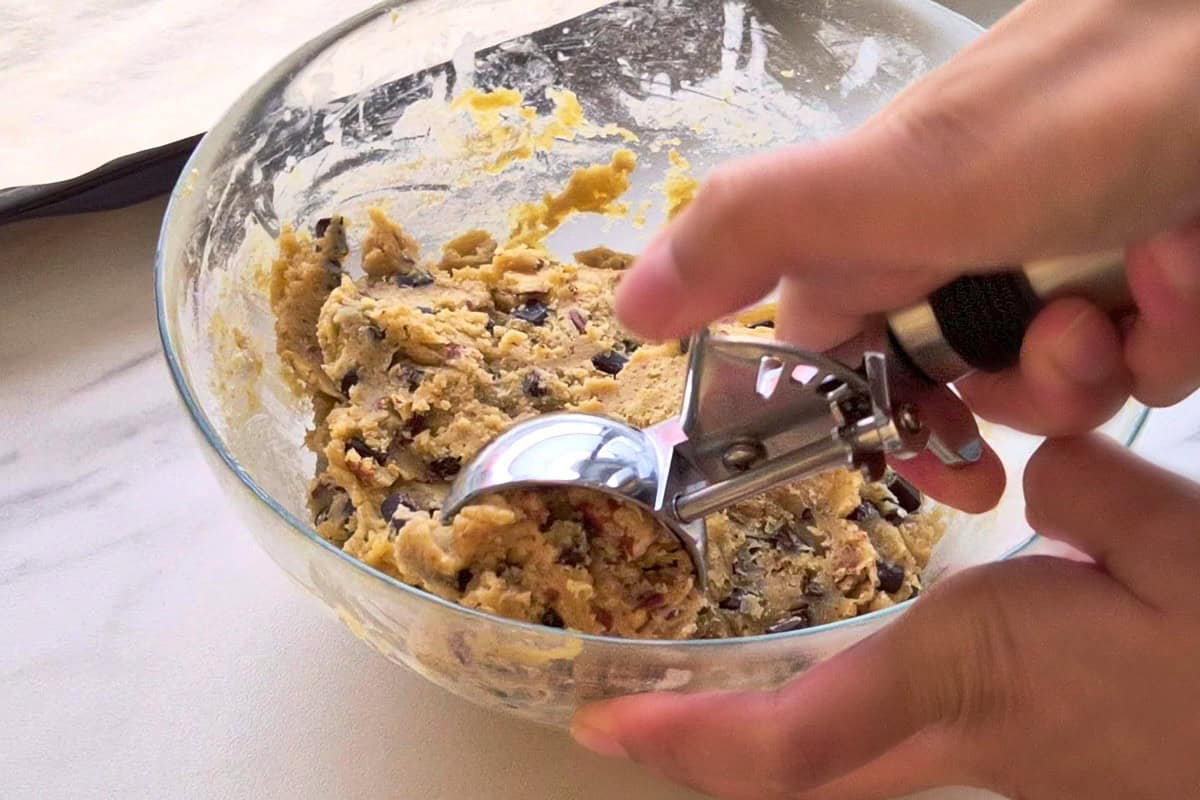 Scooping dough with a cookie scoop.