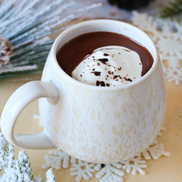 French Hot Chocolate in a white mug topped with whipped cream.