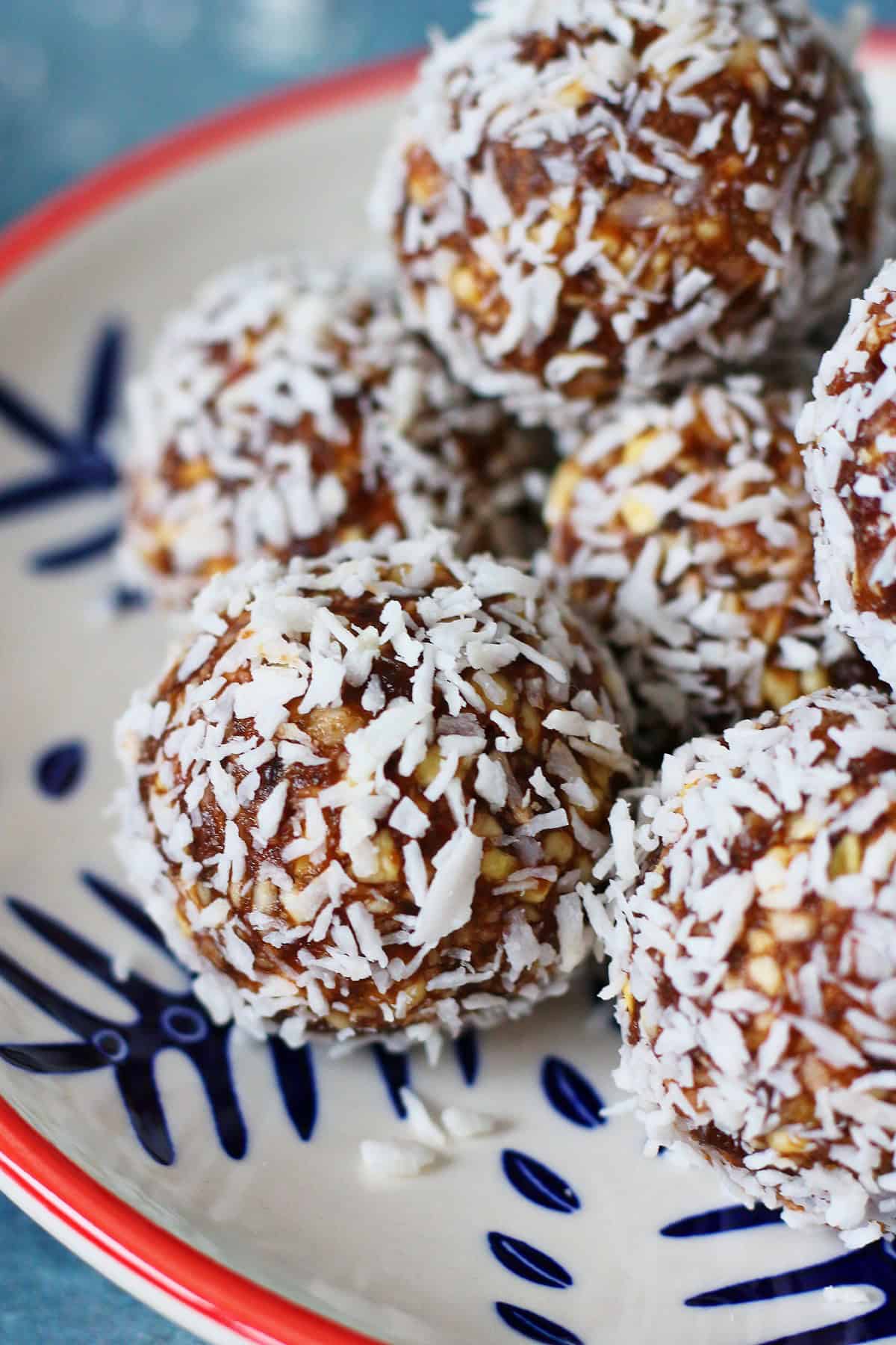 Close up of date balls covered with desiccated coconut.