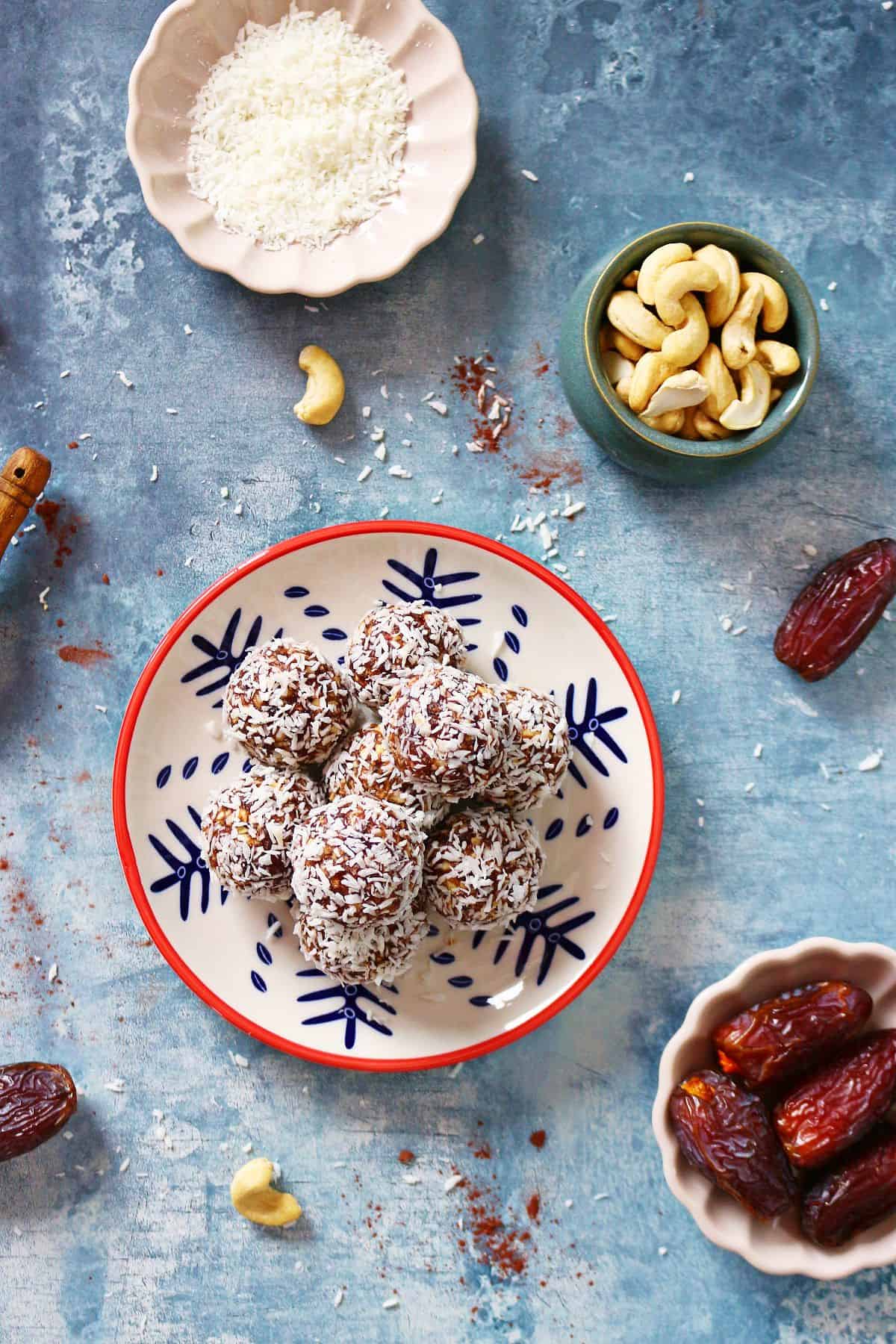 Top shot coconut date balls with whole dates, cashews and desiccated coconut.