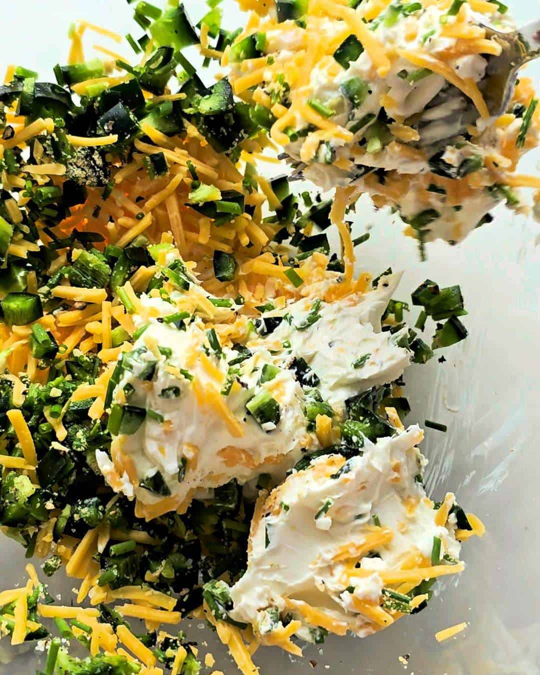 Jalapeno popper filling ingredients in a glass bowl.