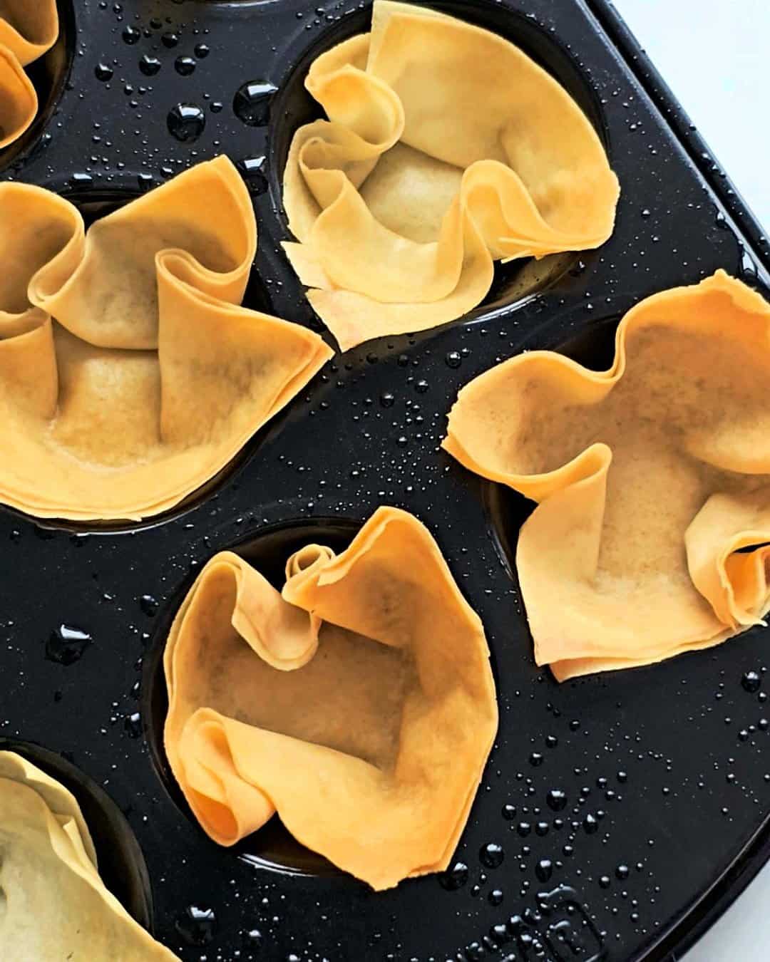 Baked wonton cups in greased muffin pan.