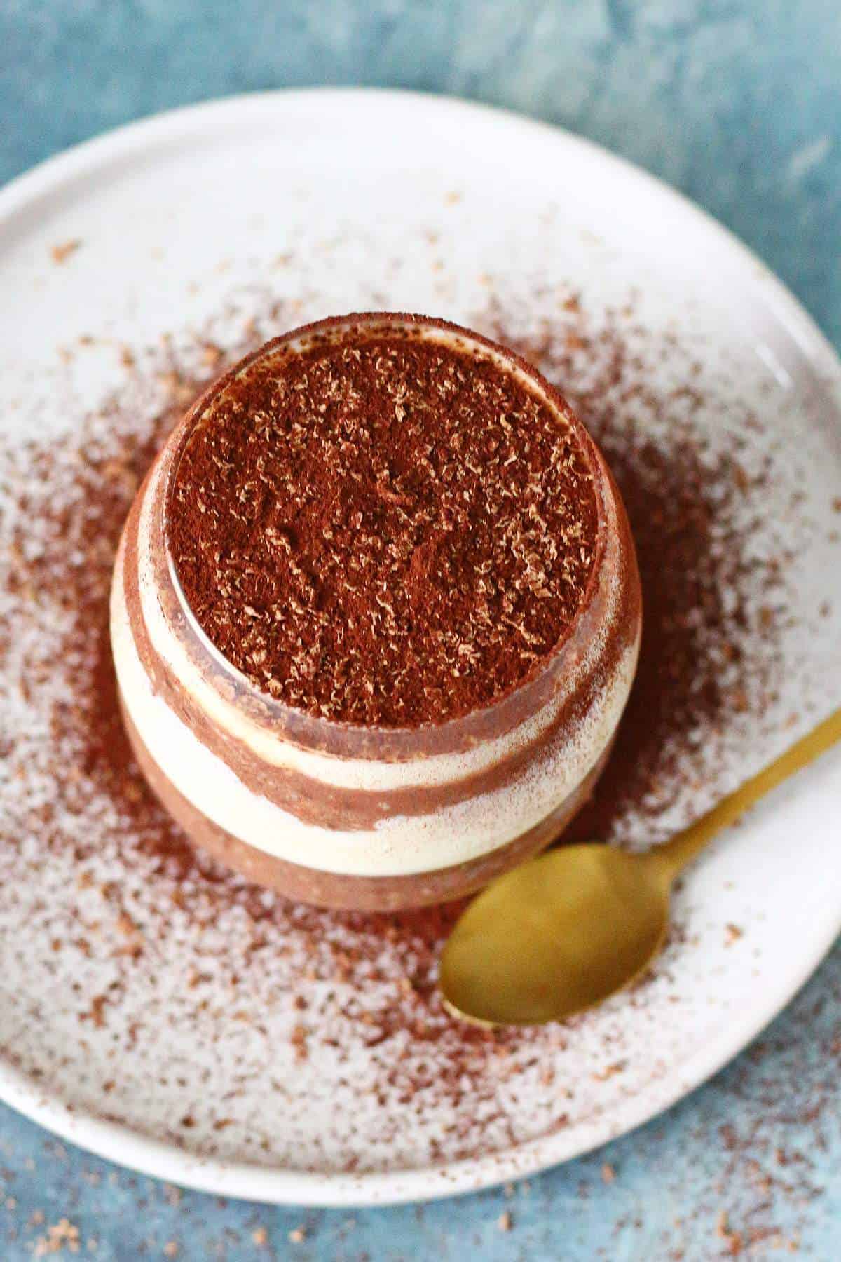 Overhead shot of cocoa powder dusted on overnight oats.