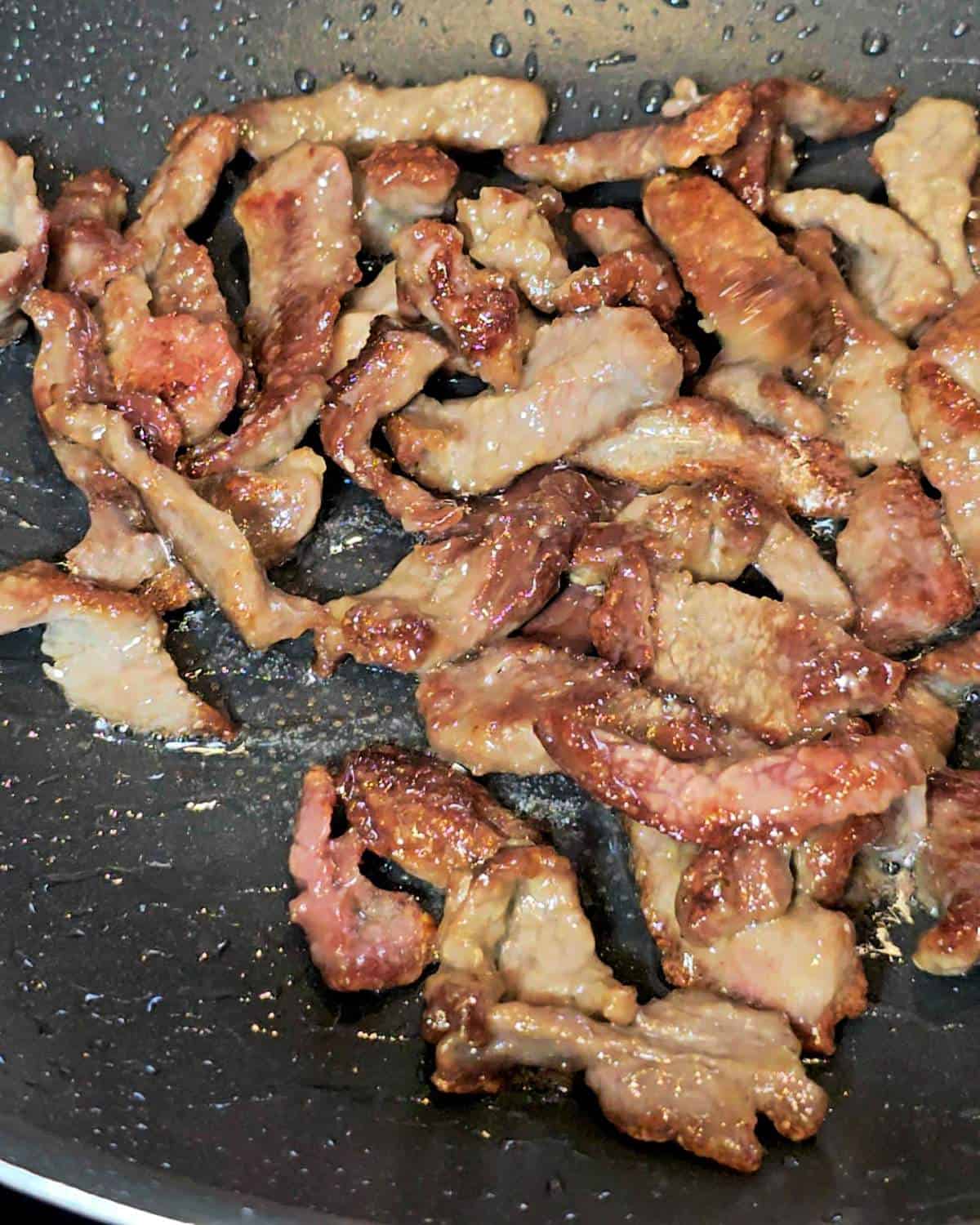 Frying beef in a wok.